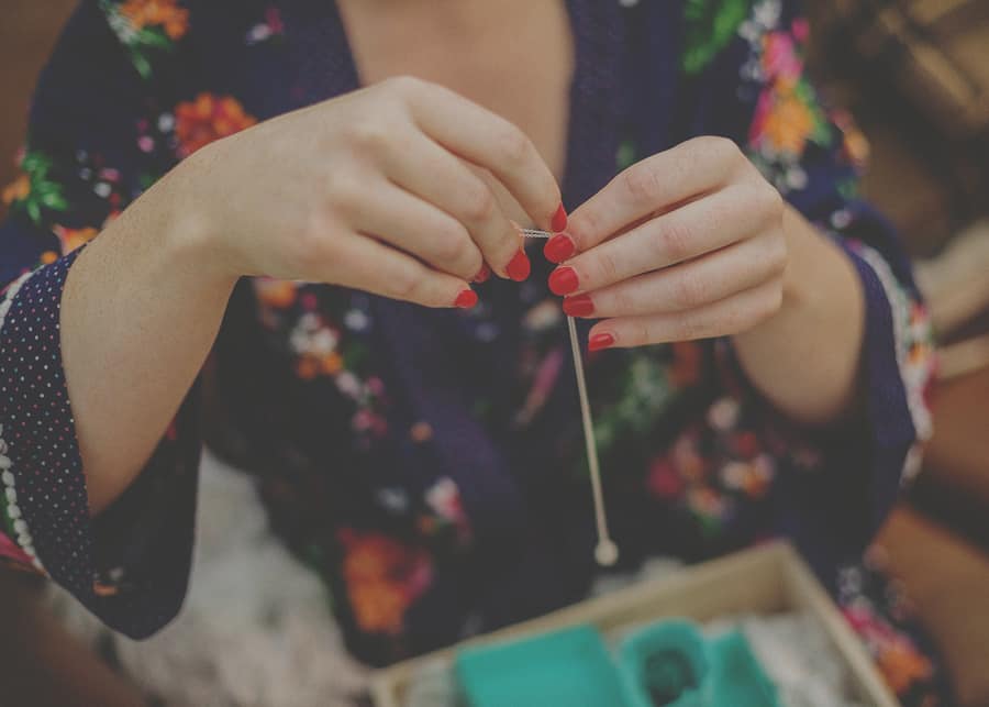 The bride picks up a necklace
