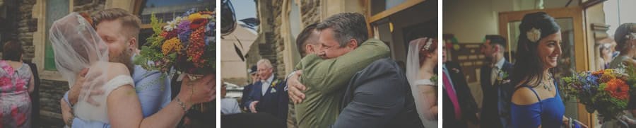Wedding guests congratulate the bride and groom outside the church