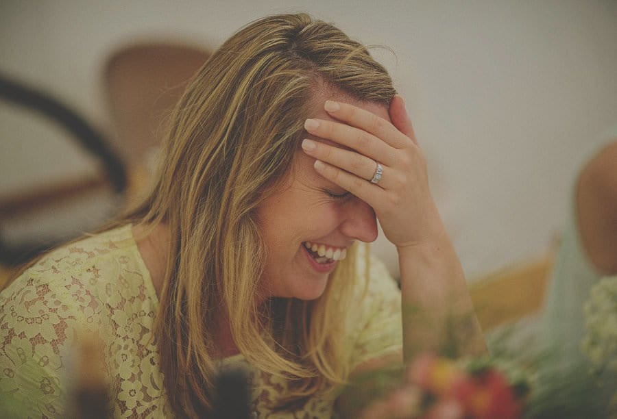 A wedding guest laughs in the marquee at Penmaen house
