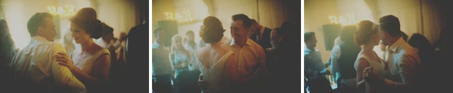The bride and groom hold each others hand and dance together