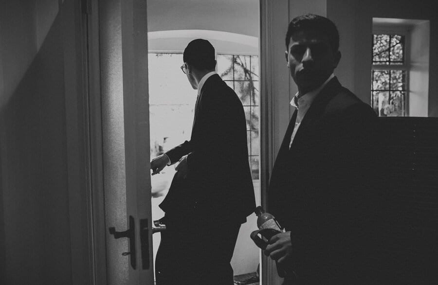 The groom and his brother open the door and leave the house