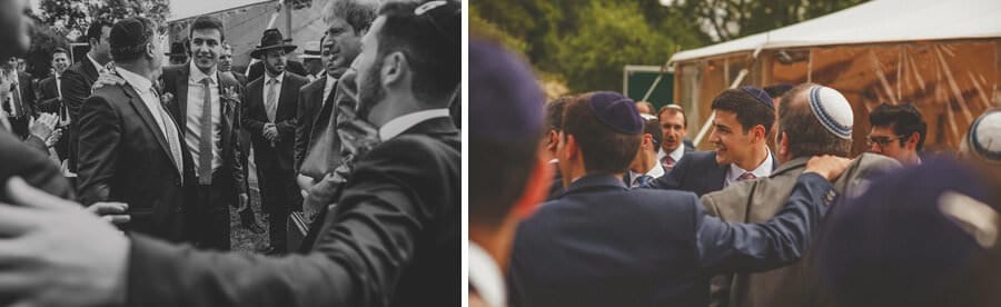 The groom and his family walk across towards where the bride and her family are sitting