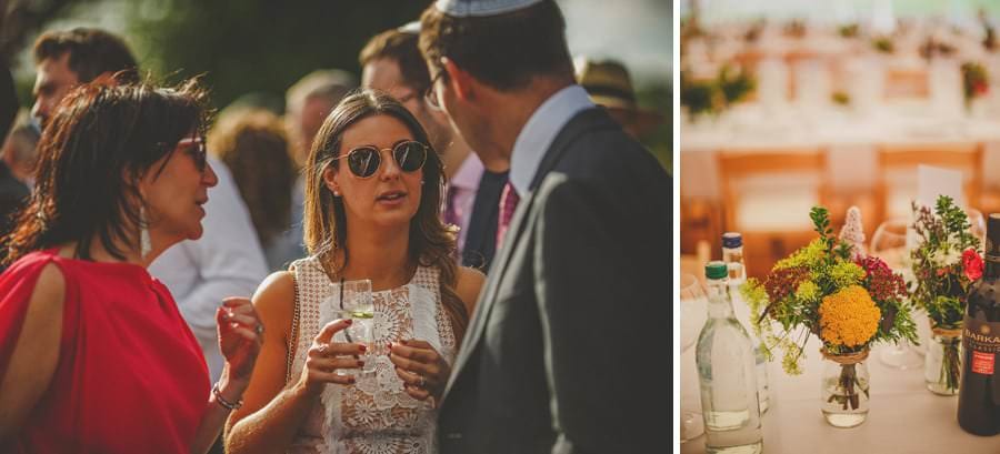 Wedding guests talk to each other on the lawn at brook farm