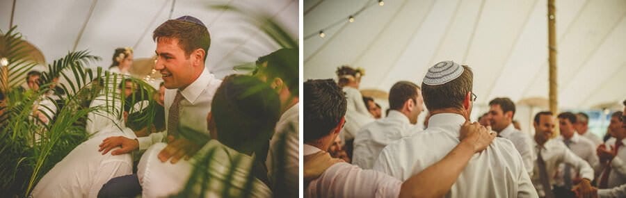 The wedding guests put the groom down in the marquee