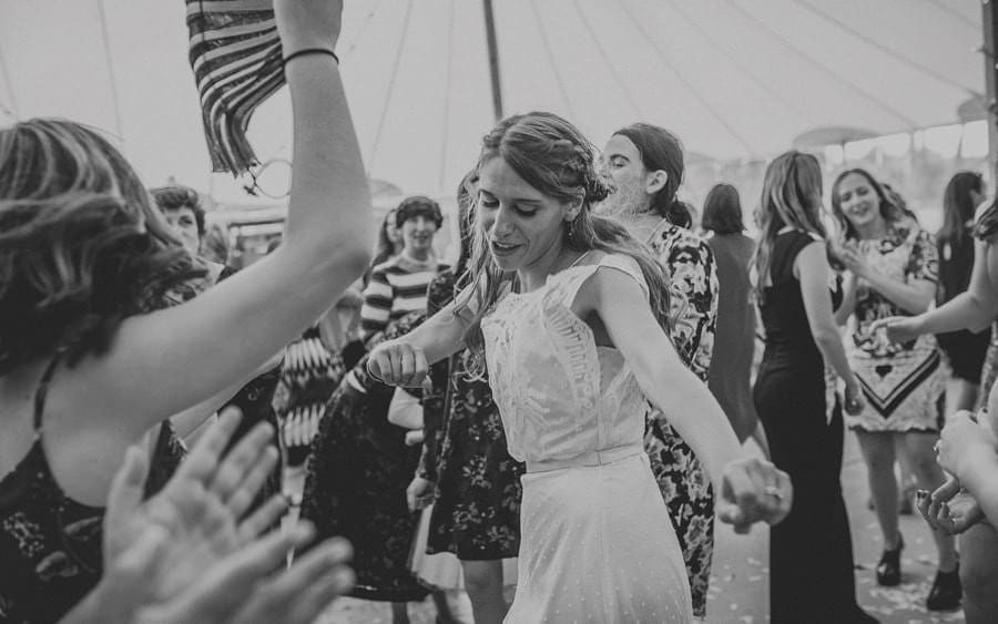 The bride dances on the dancefloor in the marquee at Brook farm