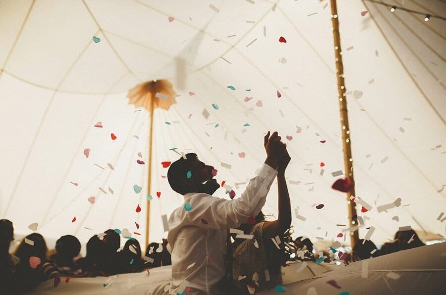Confetti is fired across the air in the marquee