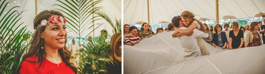 The bride embraces the groom in the marquee