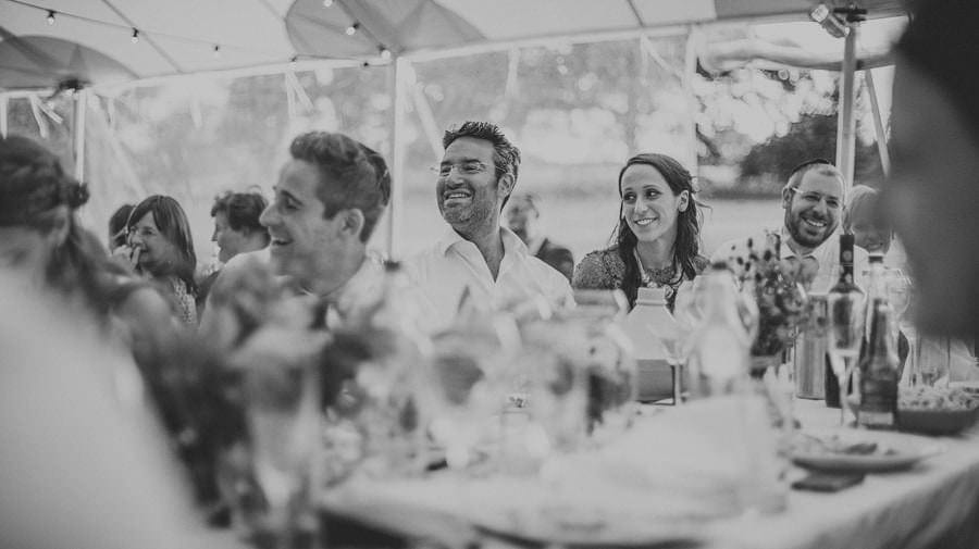 Wedding guests sat at the table listening to a wedding speech