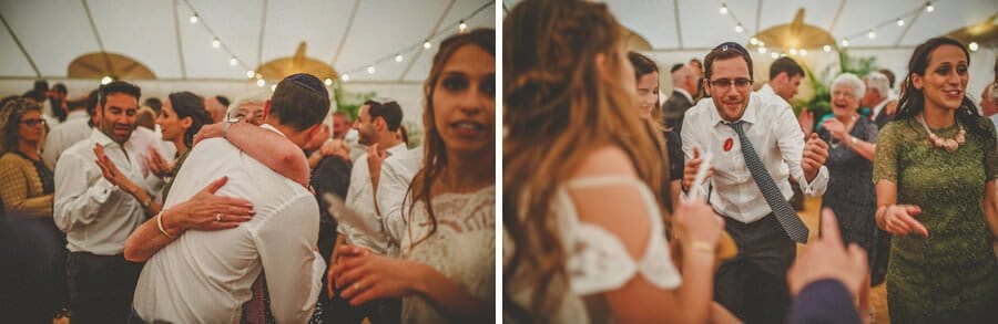 Wedding guests embrace each other on the dancefloor