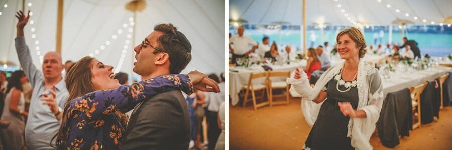 A husband and wife dance together on the dancefloor in the marquee