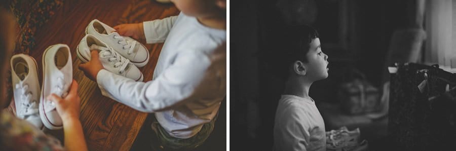 A child holds his shoes as he starts to get dressed