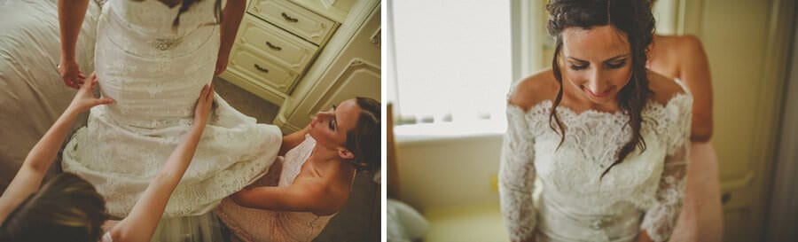 The bride and her sisters straighten her wedding dress