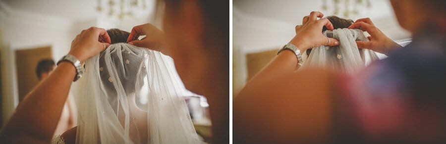 The brides veil is placed on her hair by the make up artist