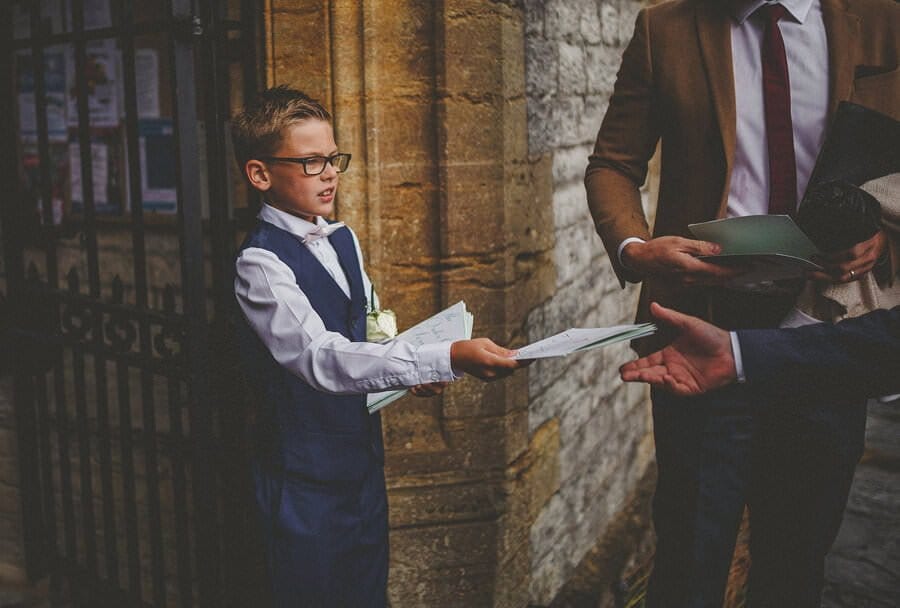 The grooms son gives out the ceremony details to the arriving guests