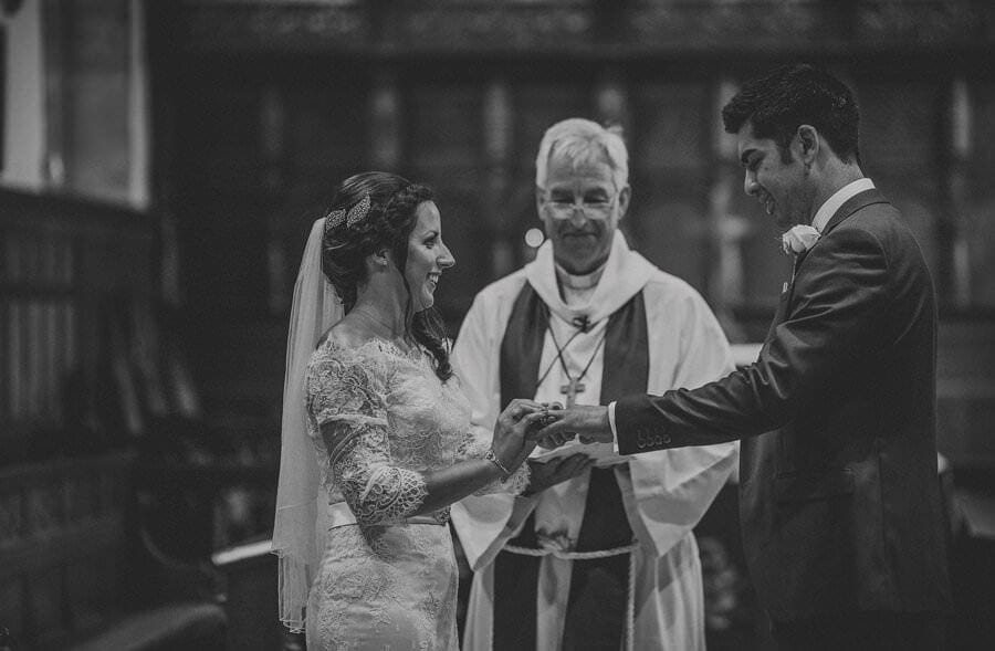The bride and groom exchange wedding rings