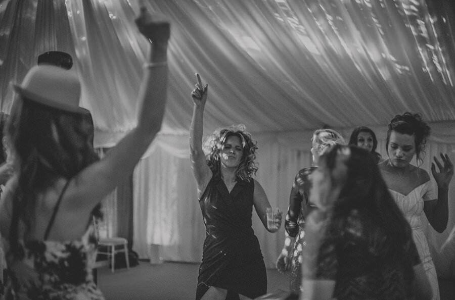 A lady raises her hand in the air