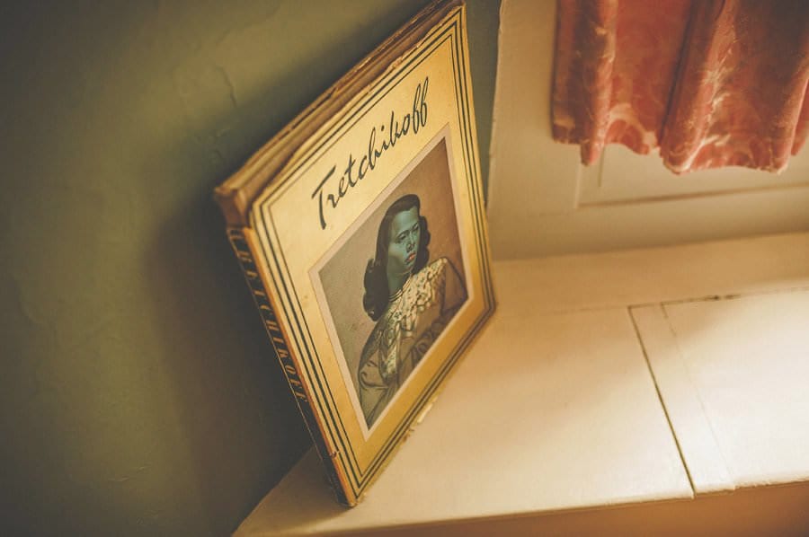 An old book lies next to the window in the groom's suite