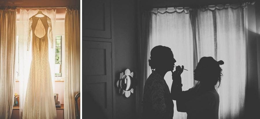 The brides dress hangs from a curtain rail next to the window of the bridal suite