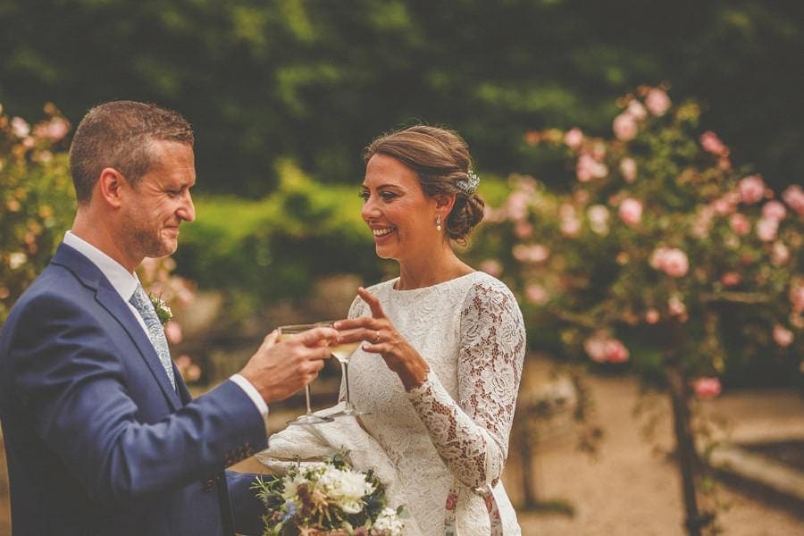 The bride and groom celebrate with a glass of champagne