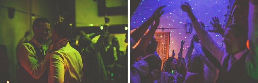 Wedding guests raise their arms in the air on the dancefloor
