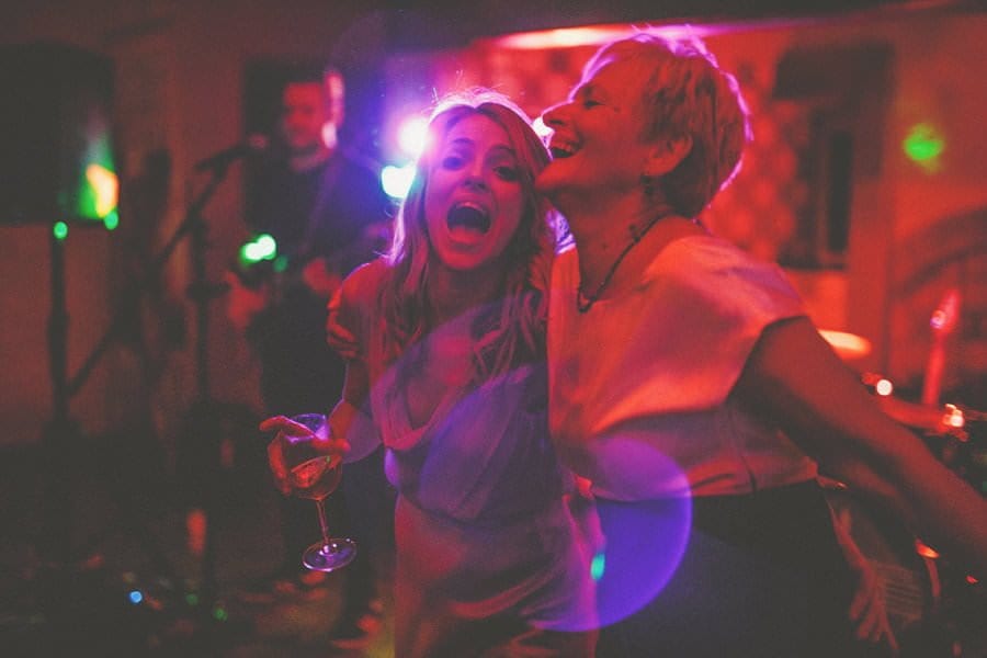 A bridesmaid and her mother dance on the dancfloor at Voewood
