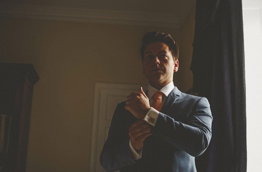 The groom adjusts his cufflinks