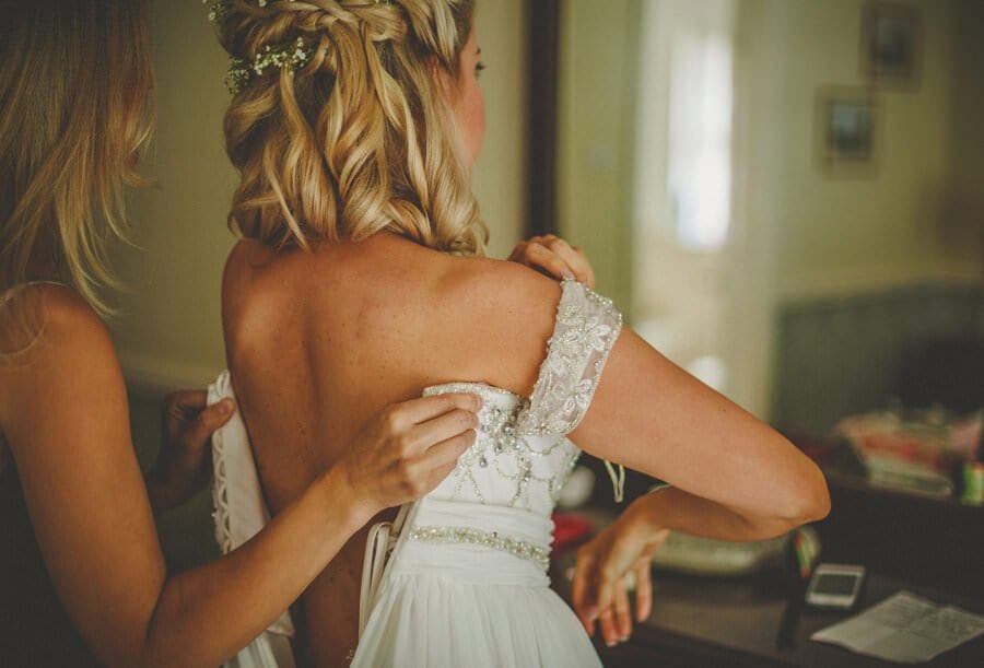 The bride puts on her wedding dress