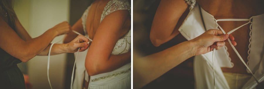 A friend helps with the wedding dress