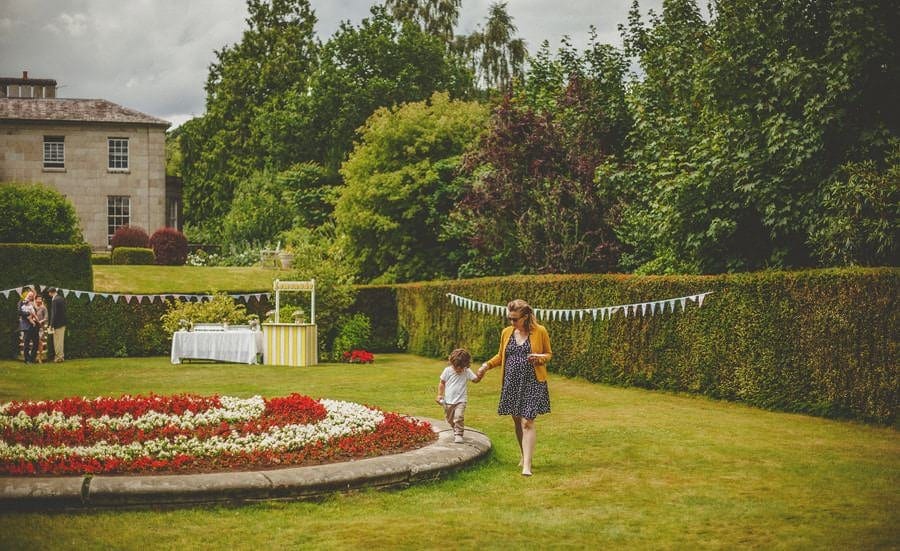 A little boy and his mother walk through the gardens at Cole Hayes Park