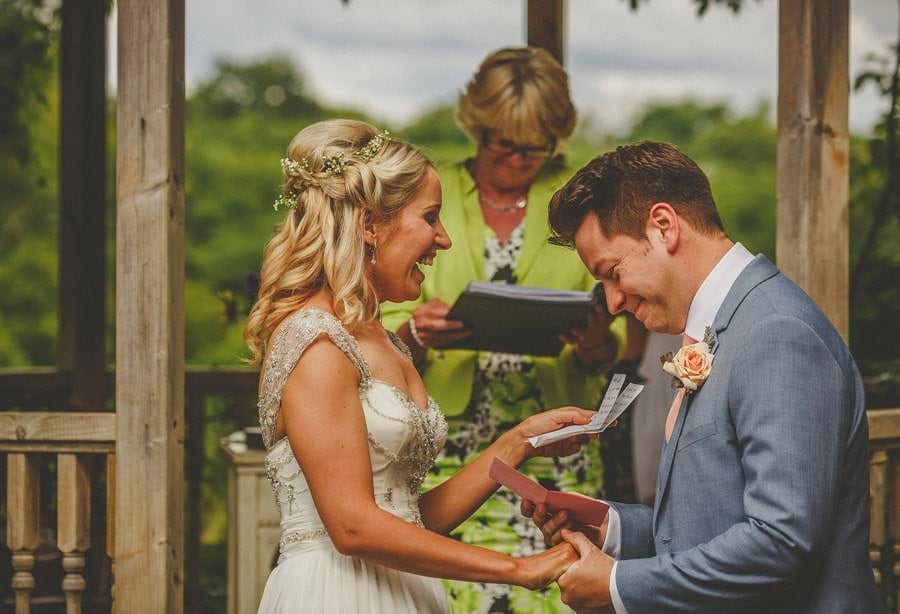 The bride and groom share a laugh together during the ceremony