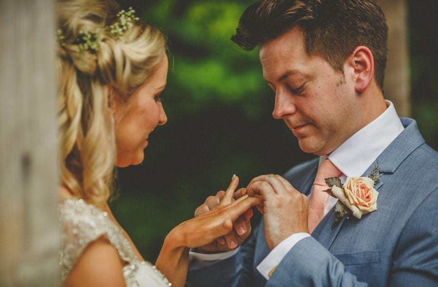 The bride and groom exchange wedding rings during the ceremony