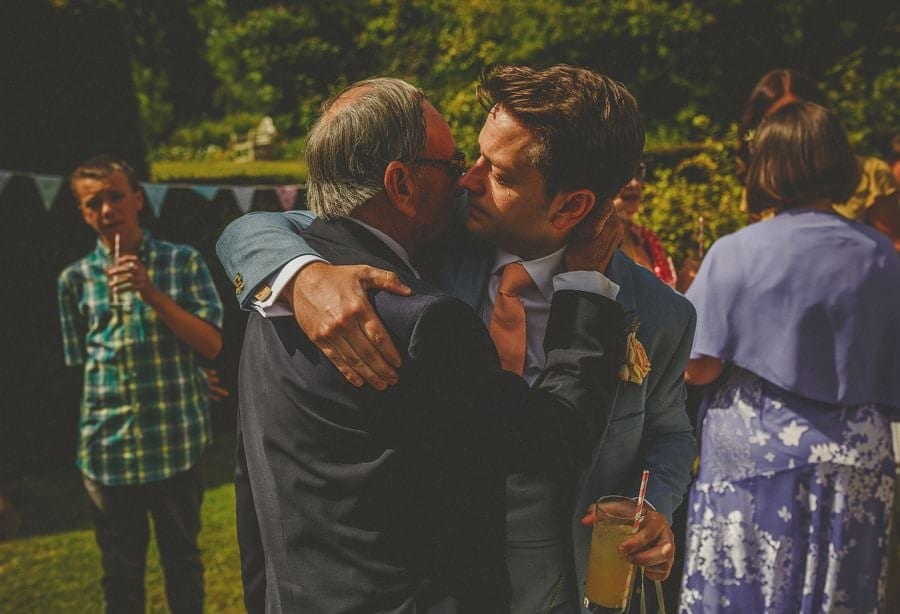 The groom crying as he embraces his father