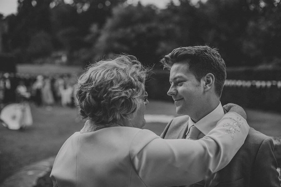 The groom embraces a member of his family