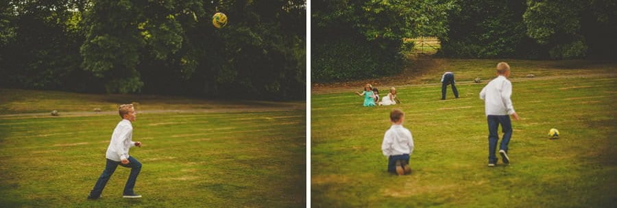 Boys playing football on the front lawn of the house