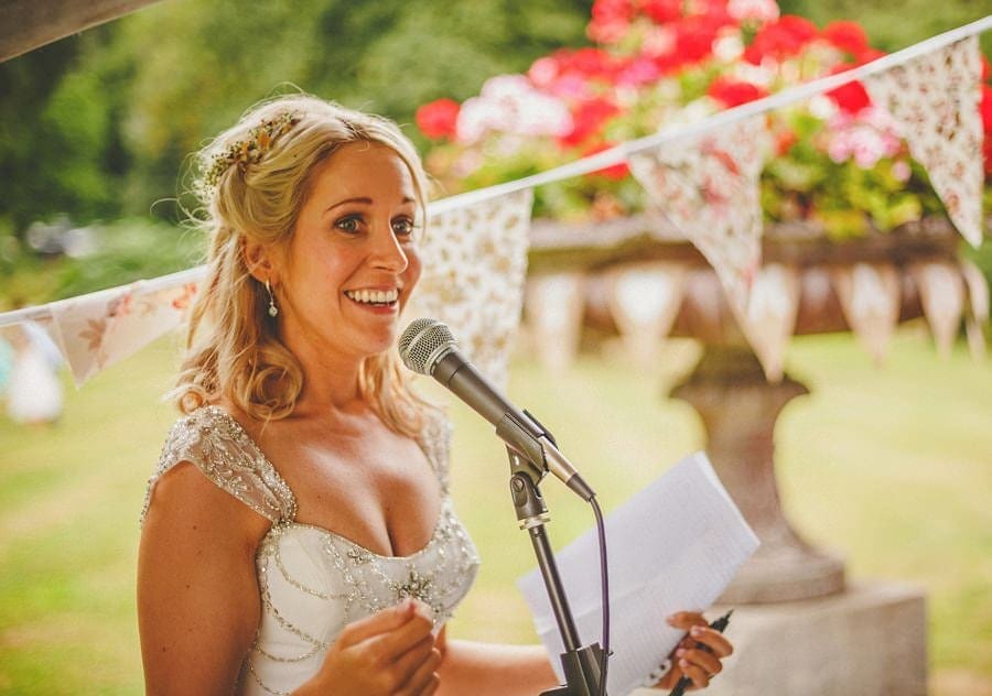 The bride smiles during her speech