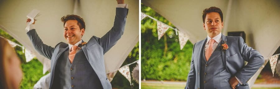 The groom raises his arms in the air and smiles