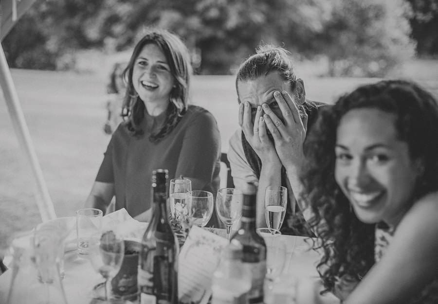 One of the wedding guests puts his hands to his face