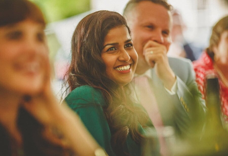 A wedding guest laughs at the best mans speech