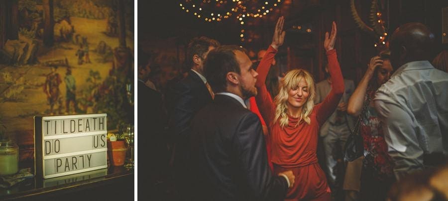 A lady dancing on the dancefloor with her arms in the air