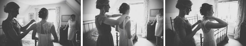 A bridesmaid helps the bride into her dress