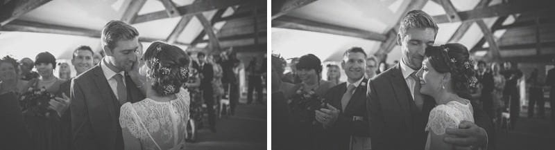The bride and groom kiss each other during the wedding ceremony