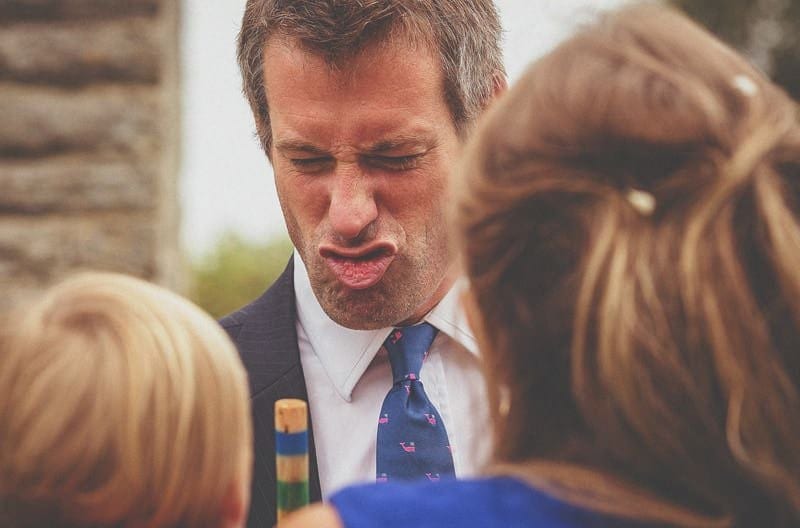 A wedding guest laughs and jokes with a young wedding guest