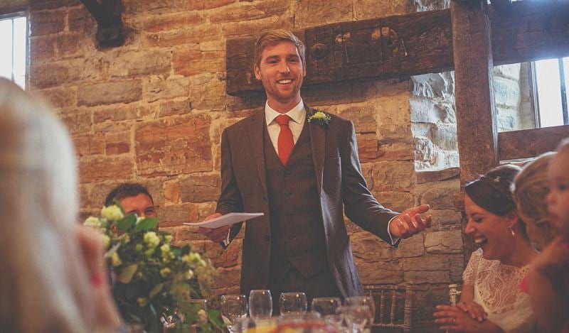 The groom stands up and delivers his speech