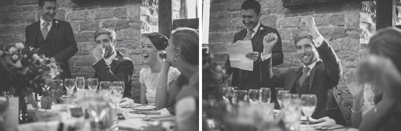 The groom raises his hands in the air during the best mans speech