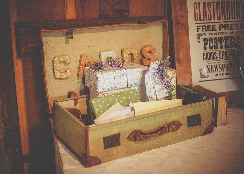 A suitcase with cards and presents on a table in the barn