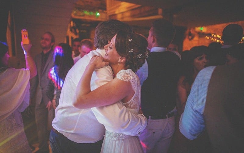 The bride embraces her father on the dancefloor at Almonry Barn