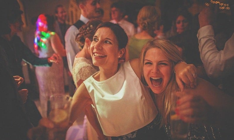 Wedding guests laughing and dancing at Almonry Barn