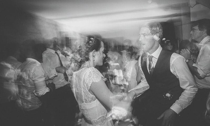 The bride and groom dancing with wedding guests on the dancefloor