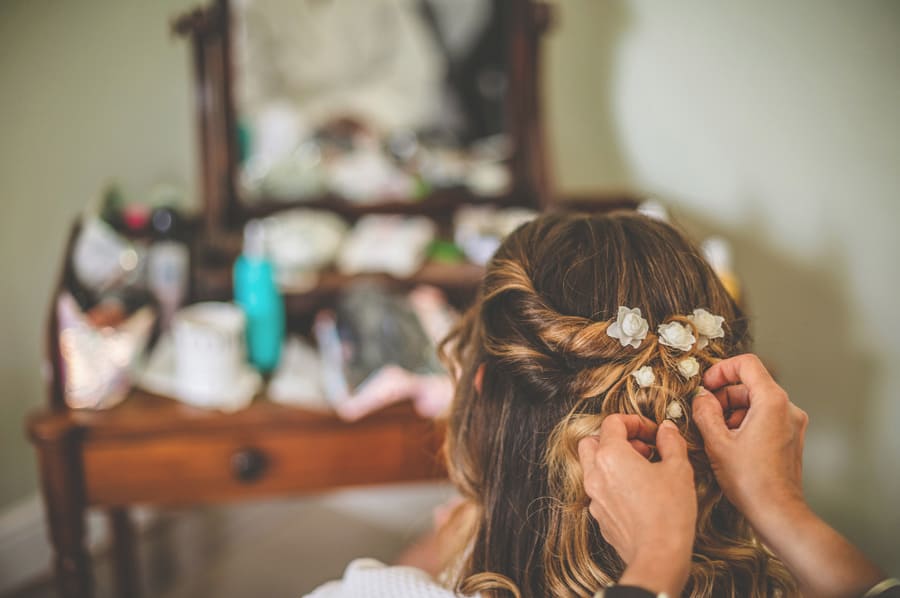 The brides flowers are plaved into her hair