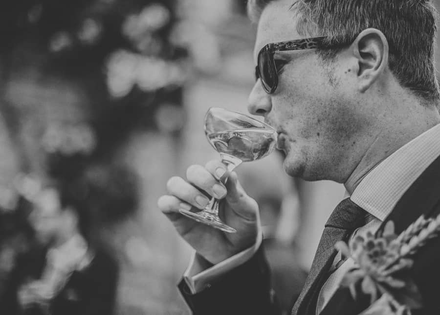 An usher drinks a glass of champagne
